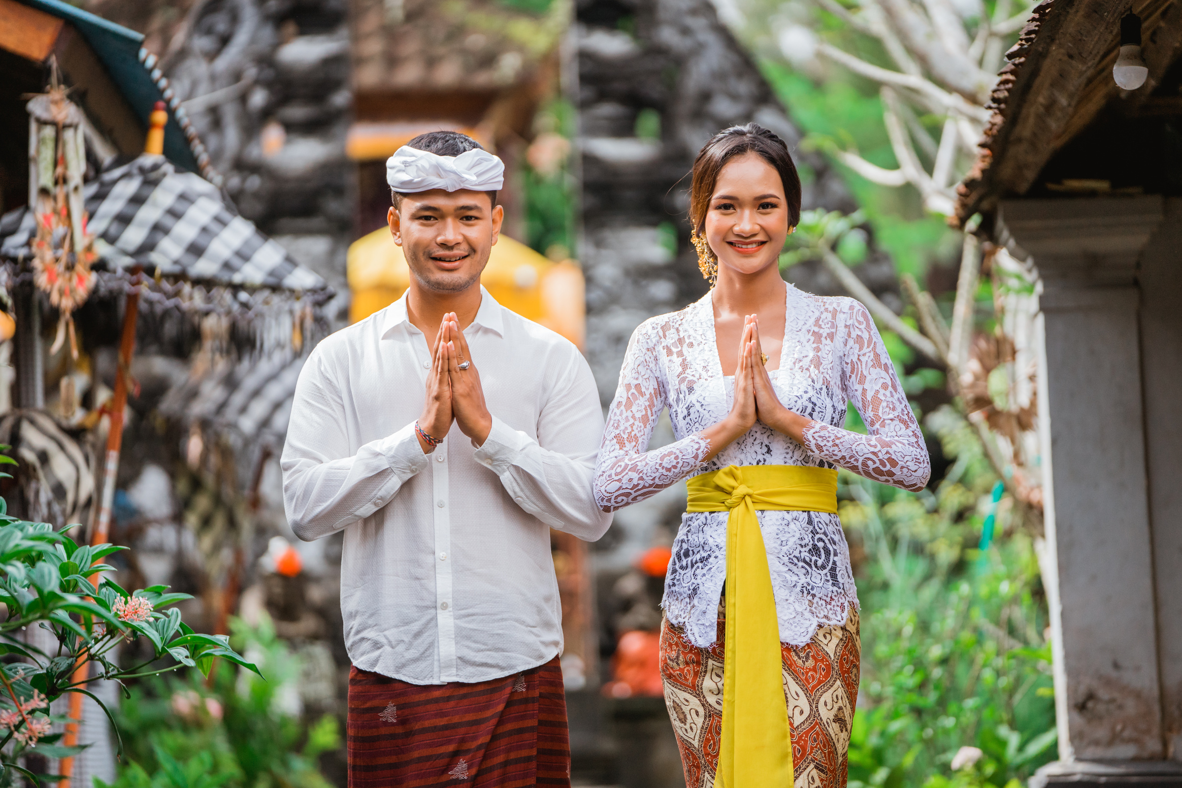 Happy Balinese Couple Greeting and Smiling Gesture at Camera